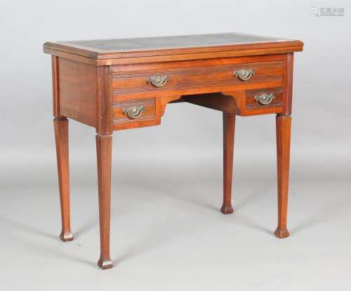 An Edwardian walnut writing table