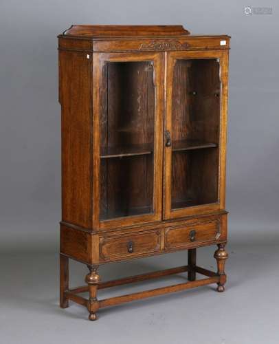 A George V oak glazed bookcase