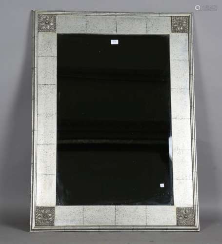 A modern silvered rectangular wall mirror with bevelled glas...
