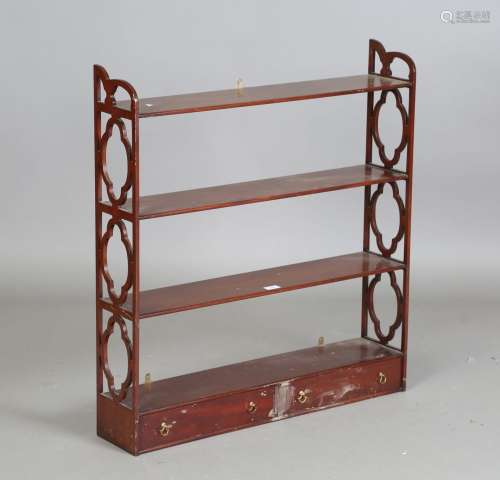 A late 20th century reproduction mahogany four-tier wall she...