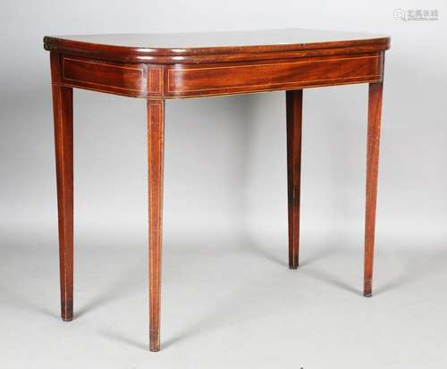 A George III mahogany fold-over tea table with boxwood strin...