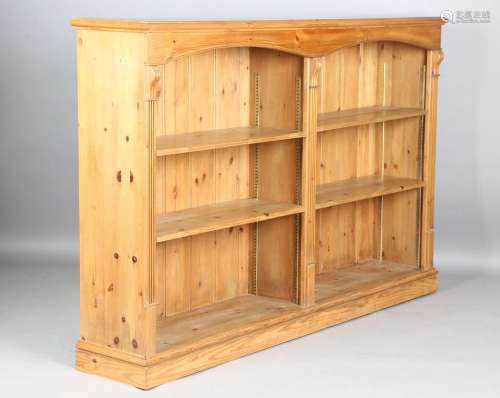A modern reproduction pine open bookcase