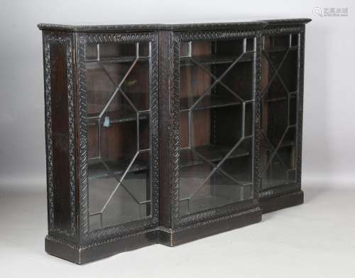 A late Victorian stained oak breakfront bookcase