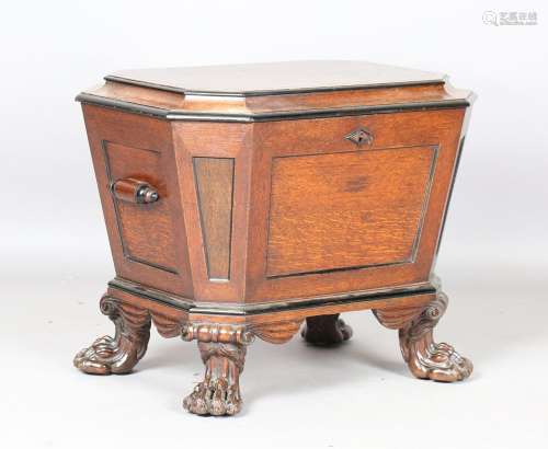 An early Victorian oak and ebonized wine cooler of sarcophag...