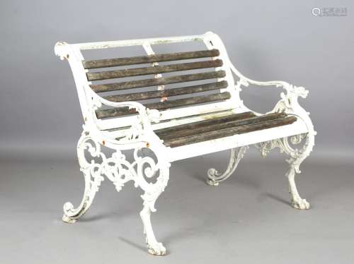A Victorian style white painted cast iron garden bench with ...