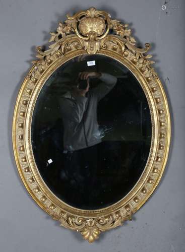 A Victorian giltwood and gesso oval wall mirror with egg and...