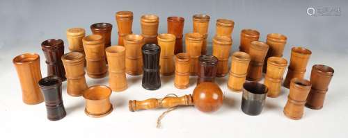 A collection of mainly 19th century treen dice shakers and a...