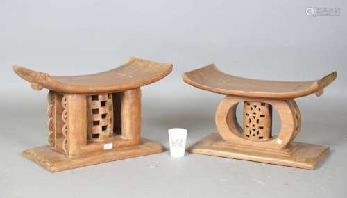 A pair of mid-20th century Ashanti carved wooden stools with...
