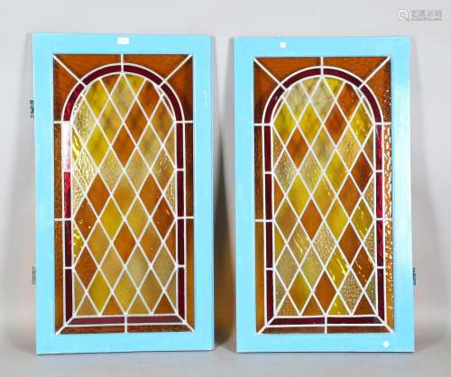 A pair of early 20th century stained and leaded glass window...