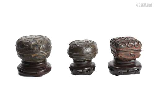 Three Bronze Boxes And Covers, With Wooden Stand.