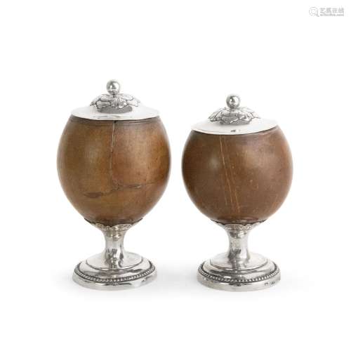 A PAIR OF GEORGE III PROVINCIAL SILVER MOUNTED COCONUT CUPS ...