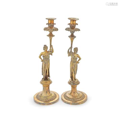A MATCHED PAIR OF GEORGE III CARYATID SILVER-GILT CANDLESTIC...