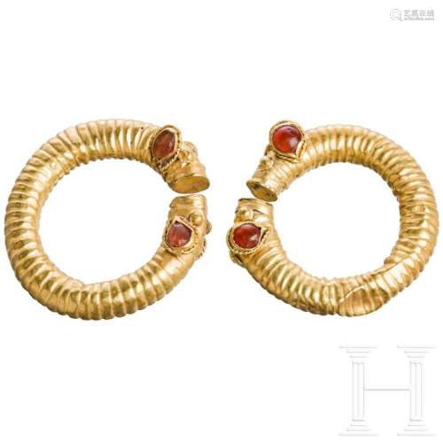 Two Greek golden curl rings with stylized animal heads, mid-...