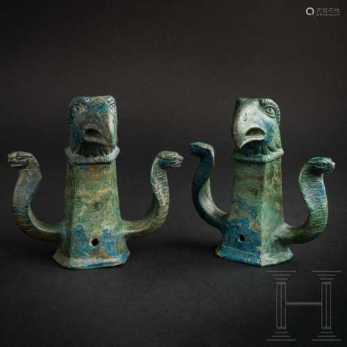 Two Roman bronze chariot suspensions with heads of cobras an...