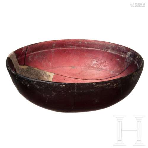 A Roman aubergine-coloured glass bowl, late 1st century B.C....
