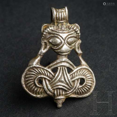 A silver Viking pendant with an animal's head and entwin...