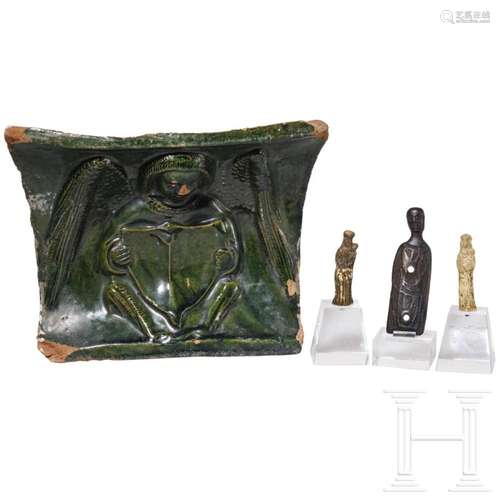 Three medieval metal figurines and a stove tile with an ange...