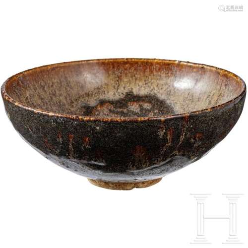 A Jizhou tea bowl with papercut resist-decoration on the ins...