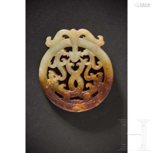 A round Chinese jade pendant with dragon and phoenix, 20th c...