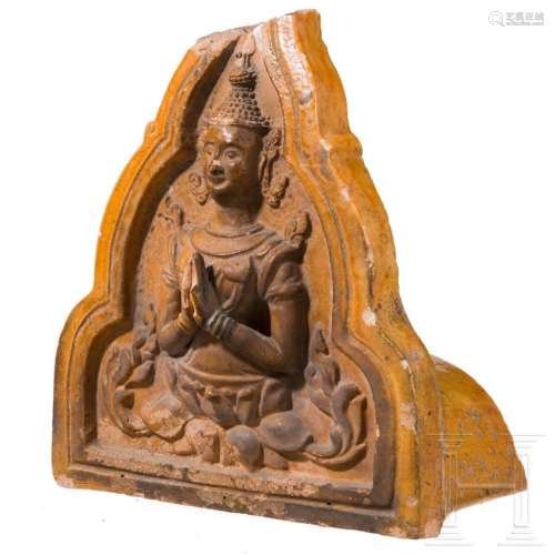 An orange-glazed front of a Thai roof tile (end of a monk ti...