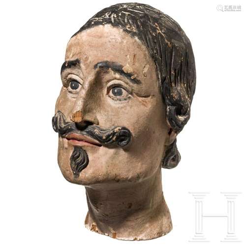 A painted German wooden head of a harness doll, circa 1900