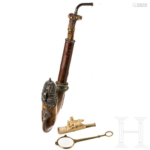 A silver-mounted wooden pipe, a meerschaum pipe and a gilded...