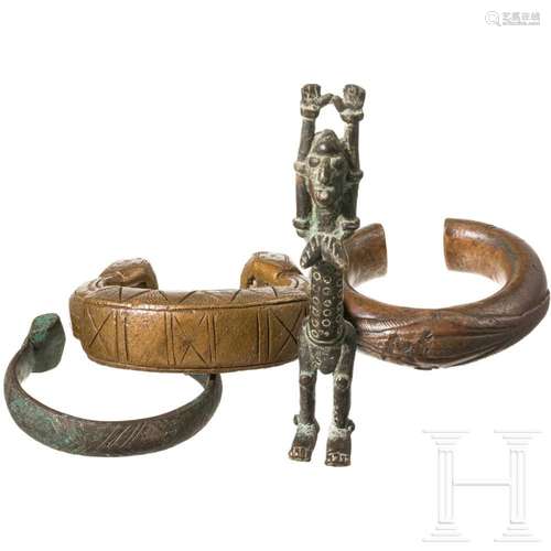 Three African manillas and a bronze figure, 19th/20th centur...