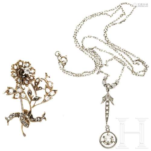 A flower-shaped gold brooch and a platinum pendant with diam...