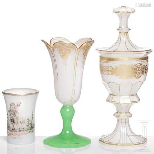 A Bohemian milk glass goblet with cover, beaker and vase, 19...