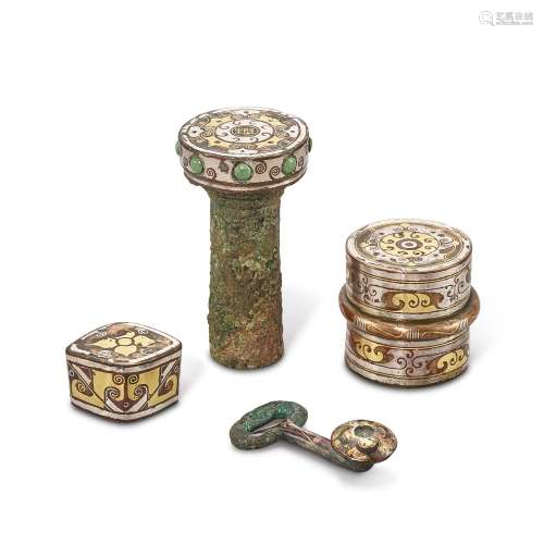 A group of four gold and silver-inlaid bronze fittings, East...