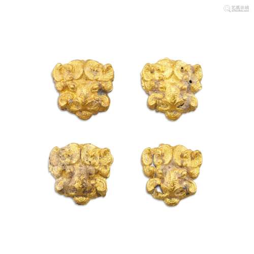 A set of four gold-alloy animal-mask form fittings, Eastern ...