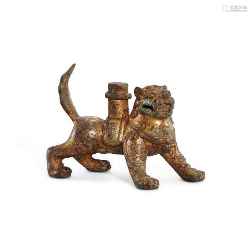 A small gilt-bronze 'lion' support, Tang dynasty 唐 铜鎏金狮...