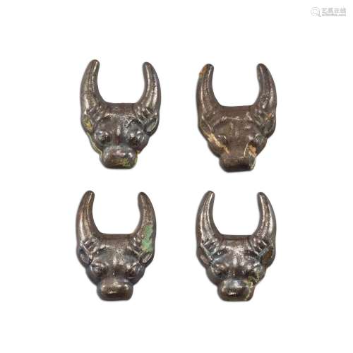 A group of four silvered bronze 'buffalo' fittings, Eastern ...
