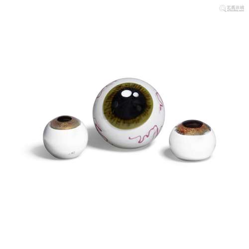 A GROUP OF THREE BLOWN GLASS PAPERWEIGHT EYEBALLS the two sm...