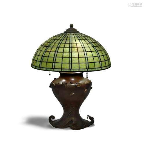 A RARE AMERICAN PATINATED BRONZE AND LEADED GLASS TABLE LAMP...