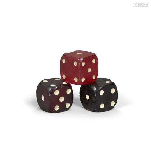 THREE BAKELITE OVERSIZED DICE comprising a translucent red, ...