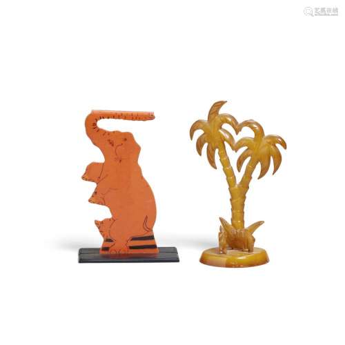 TWO FIGURAL STANDS comprising a butterscotch Bakelite palm t...