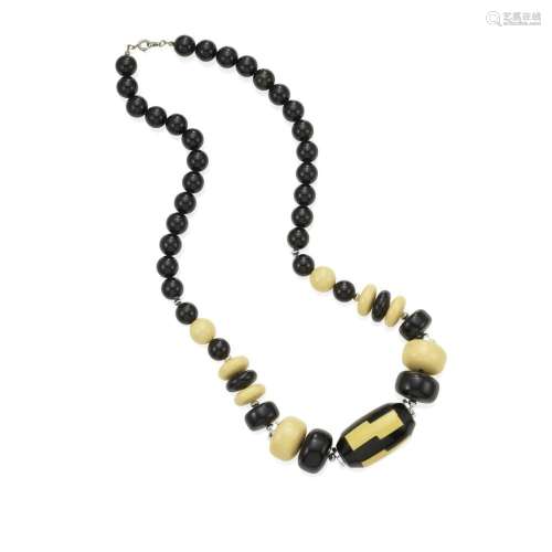 A BLACK AND CREAM BAKELITE BEAD NECKLACE with one large geom...