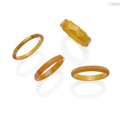 FOUR CARVED BAKELITE BRACELETS IN CREAM AND BUTTERSCOTCH dia...