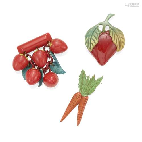 THREE BAKELITE BROOCHES comprising a brooch with two carrots...