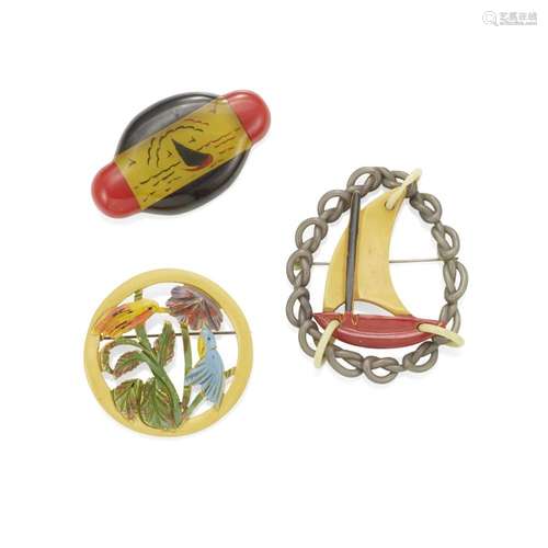 THREE BAKELITE BROOCHES comprising a Bakelite sailboat suspe...