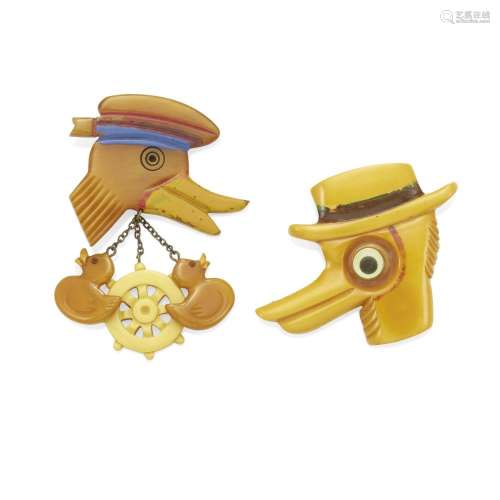 TWO HAND-PAINTED DUCK HEAD BAKELITE BROOCHES one with hat an...