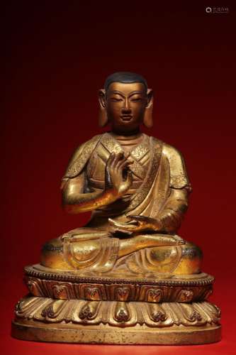 Gilt bronze figure of a seated master