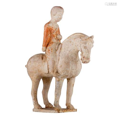 A Chinese painted pottery figure of a horse and a rider, Tan...