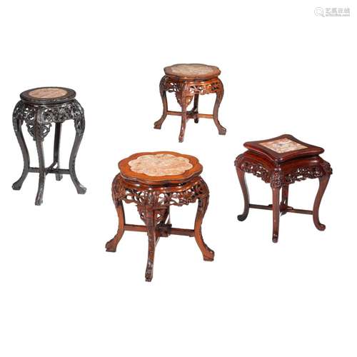 A collection of four carved low hardwood stands, with marble...