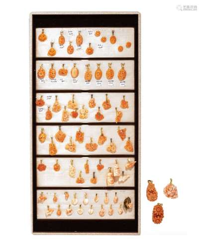 A panel with a collection of Chinese carved coral pendants, ...