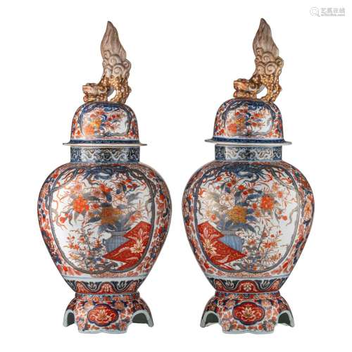 A pair of Japanese Imari covered vases, on a porcelain base,...