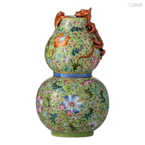 A Chinese famille rose on lime-green ground double-gourd vas...