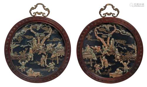A pair of Chinese bone carvings on round panels, late Qing/R...