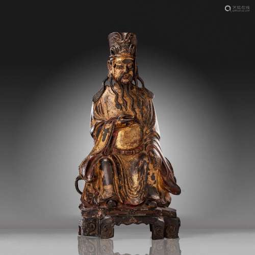 A Chinese gilt lacquered bronze figure of a dignitary, late ...